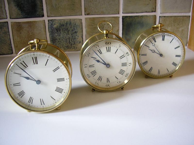 P3210003.JPG - A trio of brass cased time pieces belonging to a collector.